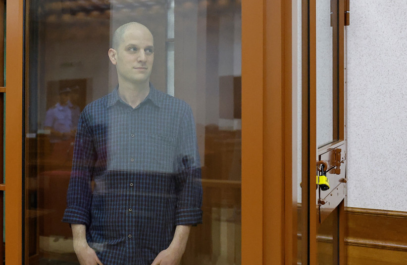  Wall Street Journal reporter Evan Gershkovich, who stands trial on spying charges, is seen inside an enclosure for defendants before a court hearing in Yekaterinburg, Russia June 26, 2024. (credit: REUTERS/EVGENIA NOVOZHENINA)