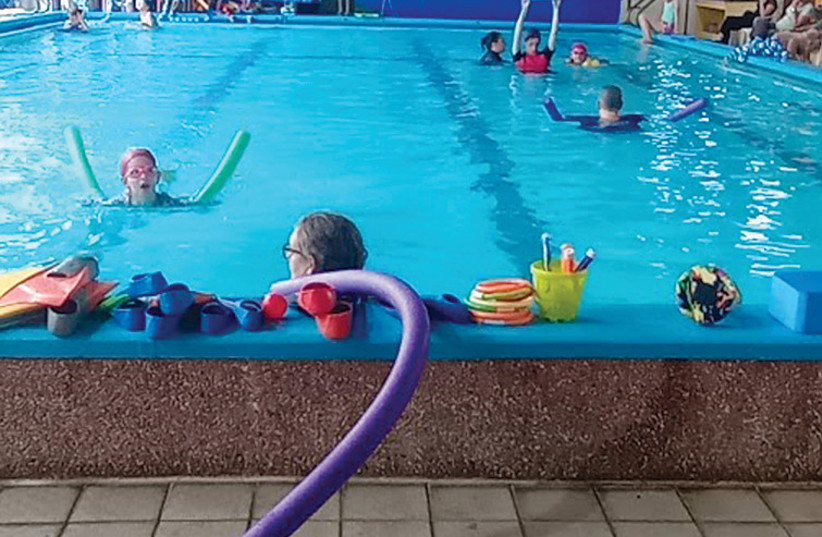  Children and trainers use the adapted hydrotherapy pool at SPIVAK. (credit: MATHILDA HELLER)