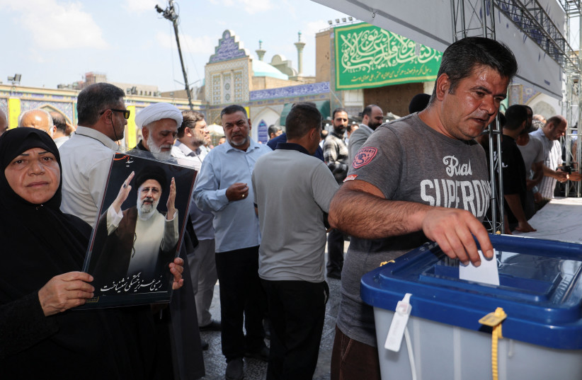  An Iranian man votes at a polling station in a snap presidential election to choose a successor to Ebrahim Raisi following his death in a helicopter crash, in Tehran, Iran June 28, 2024. (credit: MAJID ASGARIPOUR/WANA (WEST ASIA NEWS AGENCY) VIA REUTERS)