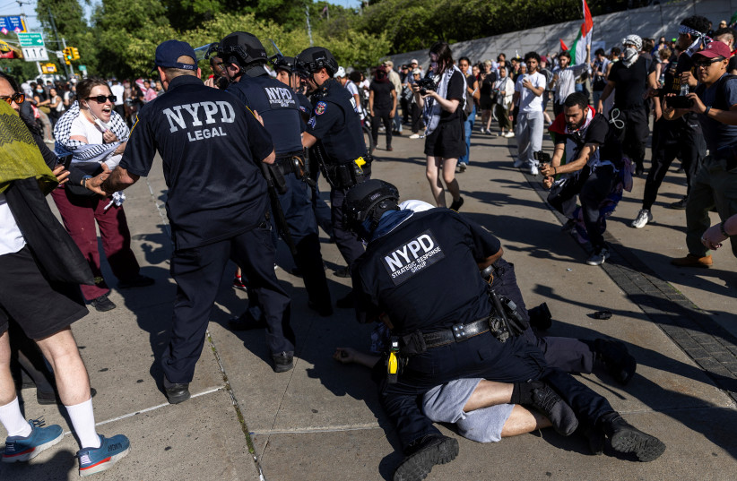  A Pro-Palestinian protestor is tackled and detained by New York Police Officers in front of the Brooklyn Museum during a protest, amid the ongoing conflict between Israel and the Palestinian Islamist group Hamas, in the Brooklyn borough of New York City, U.S., May 31, 2024.  (credit: REUTERS/EDUARDO MUNOZ)