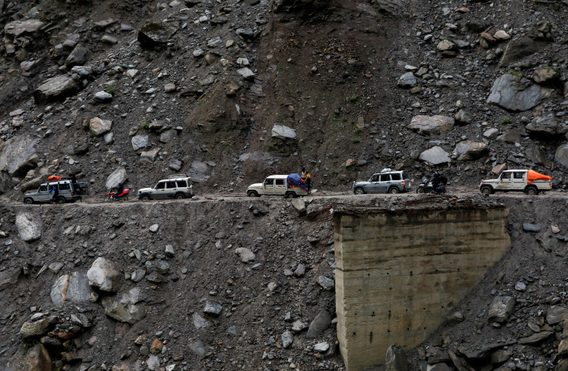 Vehicles get stuck at an area affected by landslide due to bad road conditions after three days of heavy rain at Myagdi, Nepal, October 20, 2021. (credit: NAVESH CHITRAKAR/REUTERS)