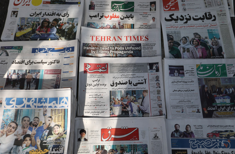Newspapers with a cover picture of Iran's presidential election are seen in Tehran, Iran June 29, 2024. (credit: Majid Asgaripour/West Asia News Agency/Reuters)