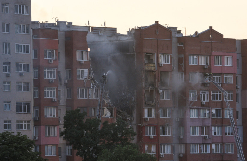 Firefighters work at a site of an apartment building hit by a Russian missile strike, amid Russia's attack on Ukraine, in Dnipro, Ukraine June 28, 2024. (credit: REUTERS/MYKOLA SYNELNYKOV)