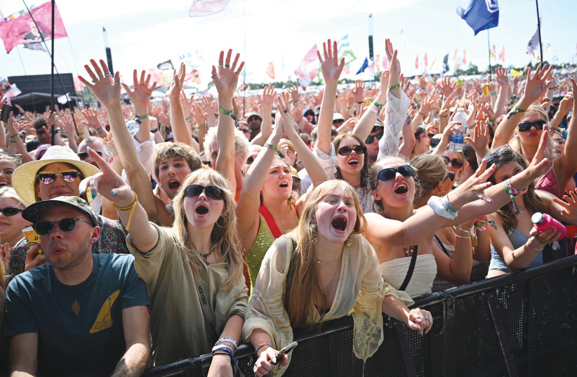  REVELERS ENJOY the Glastonbury Festival in Pilton, Somerset, Britain, on Saturday.  (credit: DYLAN MARTINEZ/REUTERS)
