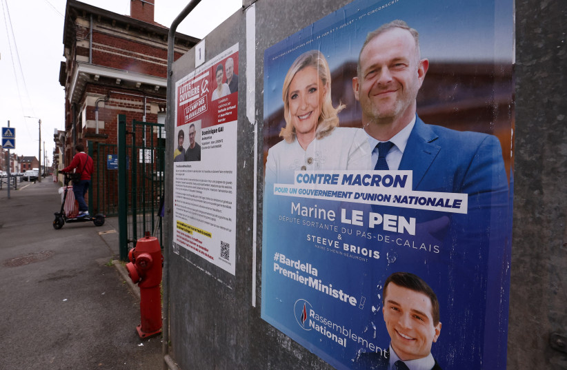  A campaign poster of Marine Le Pen, French far-right leader and far-right Rassemblement National (National Rally - RN) party candidate, is seen on an election board during the first round of the early French parliamentary elections, in Henin-Beaumont, France, June 30, 2024. (credit: REUTERS/YVES HERMAN)