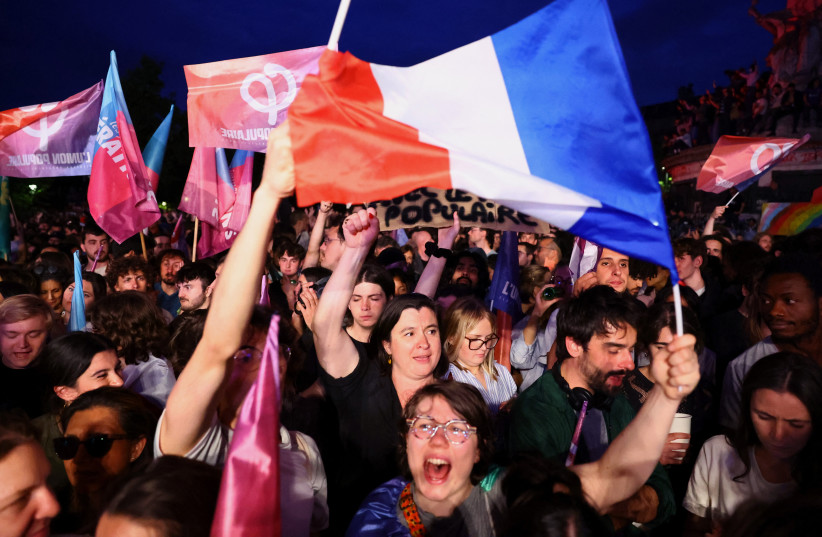  Demonstrators hold French flags and ''Popular Union'' flags in support of the ''Nouveau Front Populaire'' (New Popular Front - NFP) as they gather to protest against the French far-right Rassemblement National (National Rally - RN) party. Paris, France, June 30, 2024. (credit: REUTERS/FABRIZIO BENSCH)