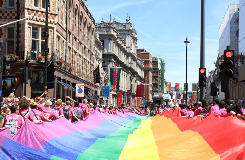 People carry a large rainbow flag, as they take part in the 2024 Pride Parade in London, Britain, June 29, 2024.  (credit: REUTERS/Mina Kim)