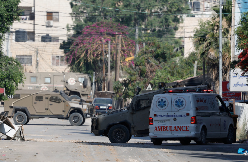  An ambulance is seen next to military vehicles during an Israeli operation in Jenin, in the West Bank June 13, 2024. (credit: REUTERS/RANEEN SAWAFTA)