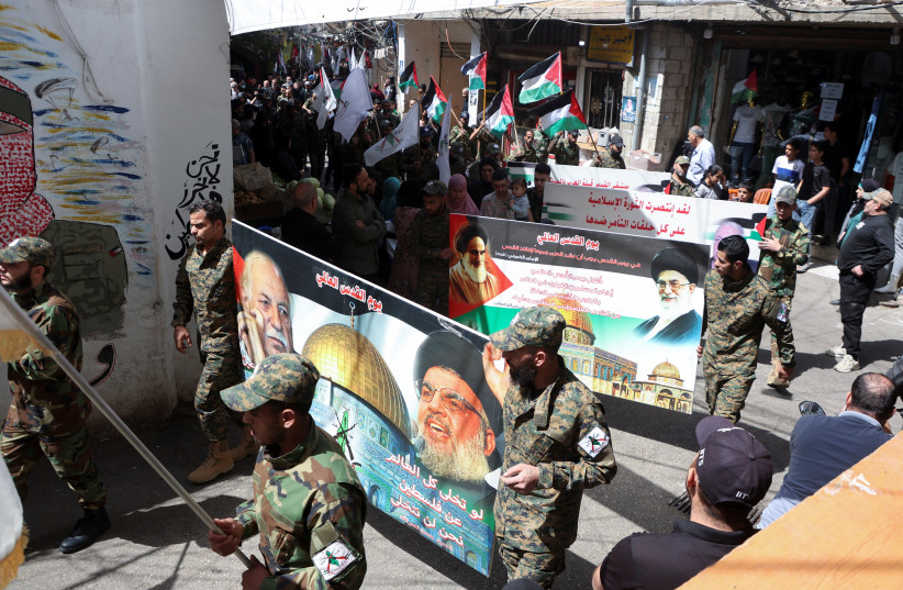  Members of the Popular Front for the Liberation of Palestine-General Command (PFLP-GC) carry banners and flags during a march marking the annual al-Quds Day, (Jerusalem Day), at Burj al-Barajneh Palestinian refugee camp in Beirut, Lebanon April 5, 2024. (credit: REUTERS/MOHAMED AZAKIR)