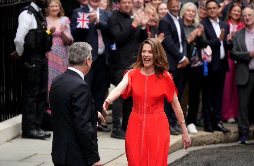 Labour leader and incoming Prime Minister Sir Keir Starmer and wife Victoria, Lady Starmer greet supporters as he enters 10 Downing Street following Labour's landslide election victory on July 5, 2024 in London, England.