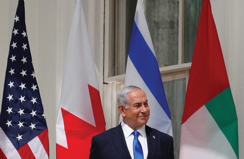 PRIME MINISTER Benjamin Netanyahu at the White House for the signing of the Abraham Accords, in Washington, 2020. Many feel that he is prolonging the war so he can hold on to power, the writer says.
