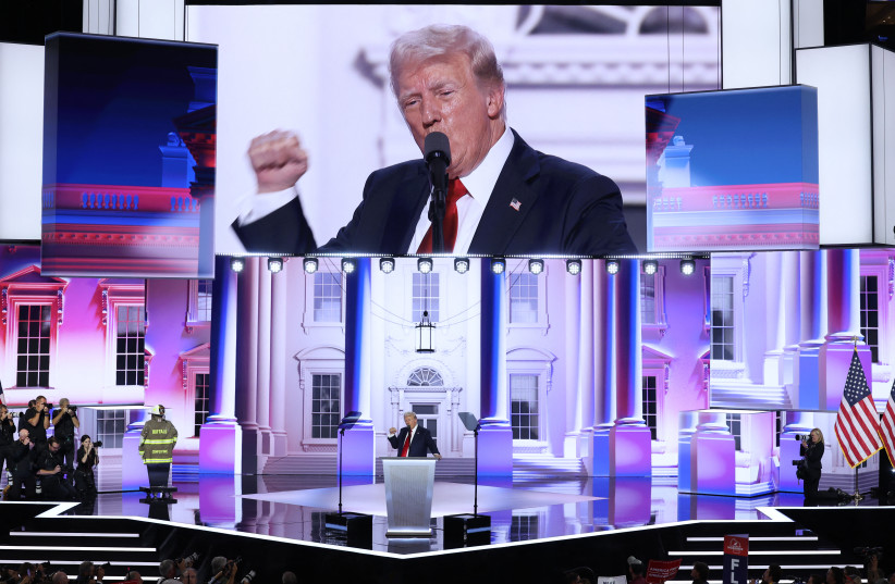 Republican presidential nominee and former UScPresident Donald Trump gives his acceptance speech as the turnout coat and helmet of former Buffalo Township Volunteer Fire Department chief Corey Comperatore, who was killed at his rally last week, is displayed at Republican National Convention.
