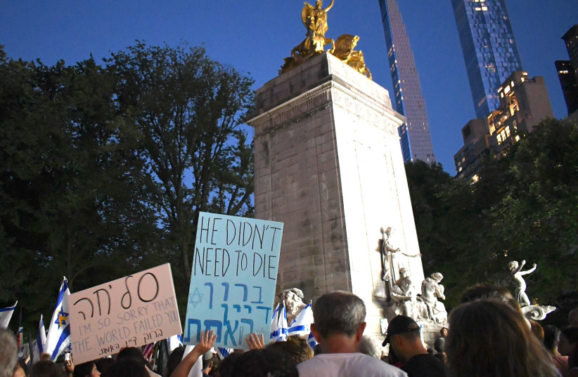 A sign at lower left reads ''sorry'' in Hebrew at a vigil in New York's Columbus Circle in memory of six Israeli hostages who were found killed in Gaza, Sept.1, 2024.
