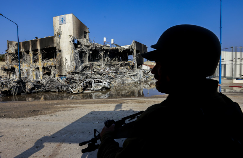 An Israeli police officer stands outside the destroyed police station in the city of Sderot, October 8, 2023
