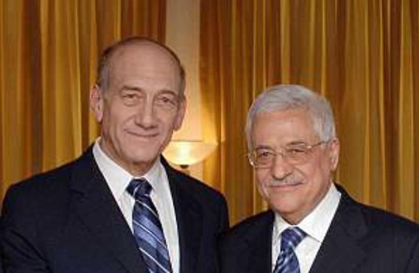 olmert and abbas shake h (photo credit: GPO [file])