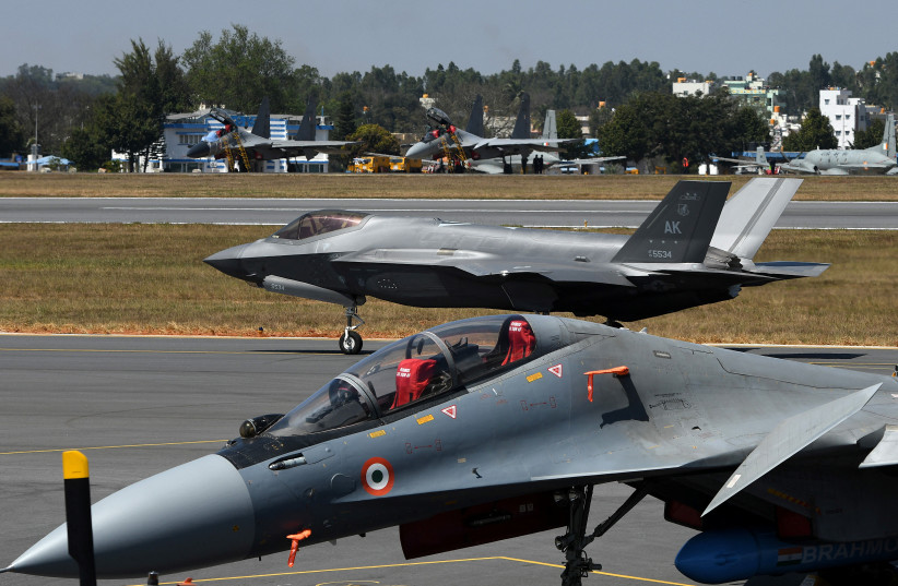 A F-35 fighter jet moves past Indian Air Force's Sukhoi Su-30MKI fighter jet parked on tarmac during the ''Aero India 2025'' air show at Yelahanka air base in Bengaluru, India.