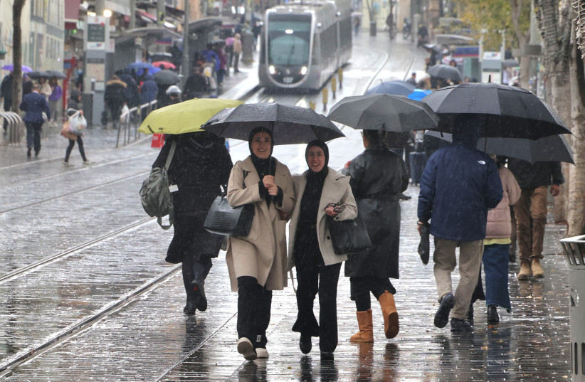 People walking in the rain on Jaffa Road, Jerusalem, December 28, 2025.