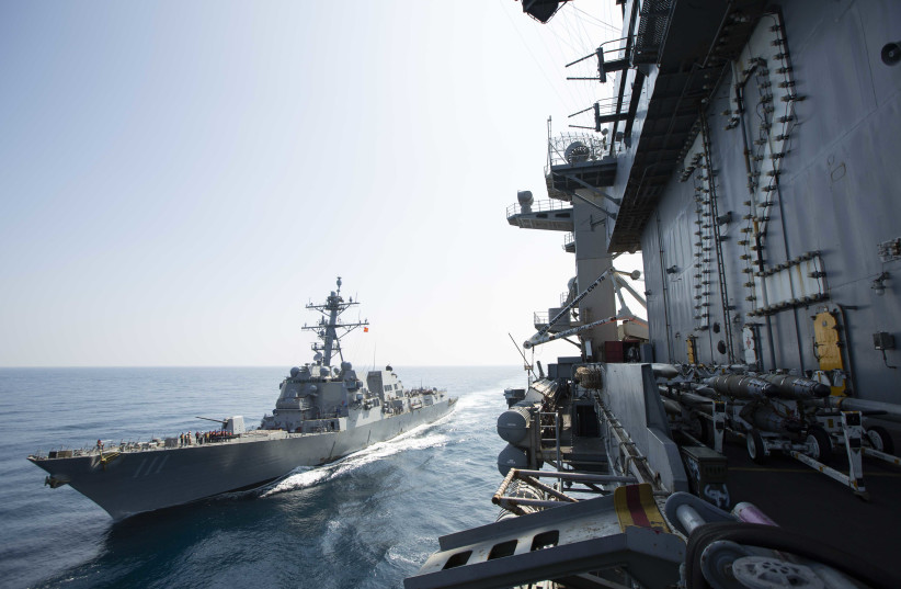 The Nimitz-class aircraft carrier USS Abraham Lincoln (CVN 72) sails alongside the Arleigh Burke-class guided-missile destroyer USS Spruance (DDG 111) in the U.S. 5th Fleet area of operations.