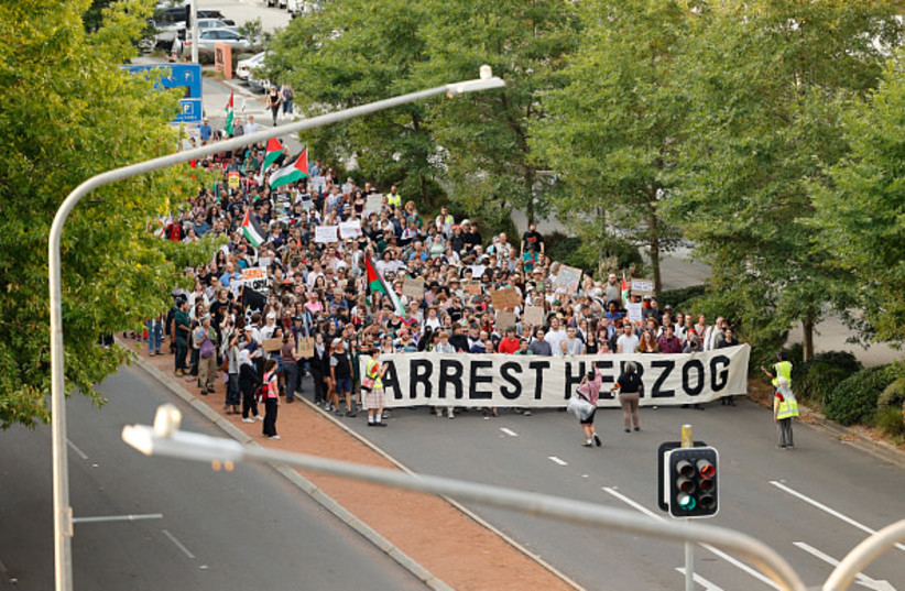 Protestors march through Canberra city centre during a protest against the visit of Israel's President Isaac Herzog on February 09, 2026 in Canberra, Australia.