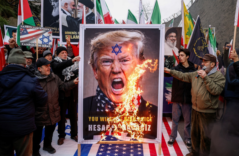 Demonstrators burn a poster of US President Donald Trump during a rally in support of the Iranian people, amid recent tensions between the United States and Iran, outside the US Consulate General in Istanbul, Turkey, February 1, 2026.