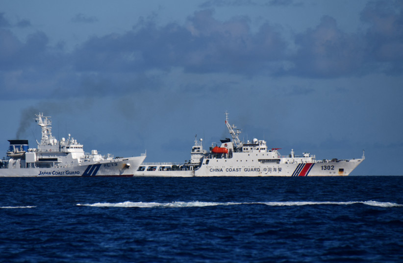 A China Coast Guard vessel sails near a Japan Coast Guard vessel around a group of disputed islands called Senkaku Islands in Japan, also known in China as Diaoyu Islands, September 14, 2025.