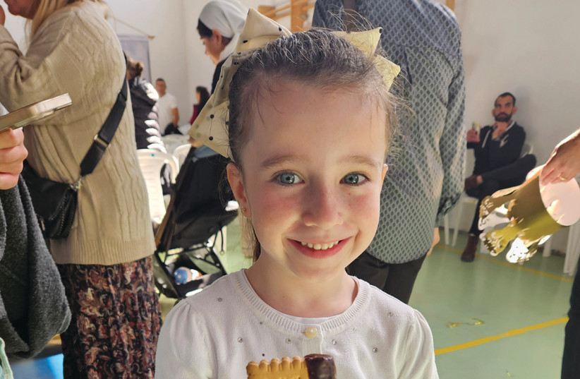 Teacher Yael crowns every first grader. Ye’ela gets an edible ‘siddur’ too.