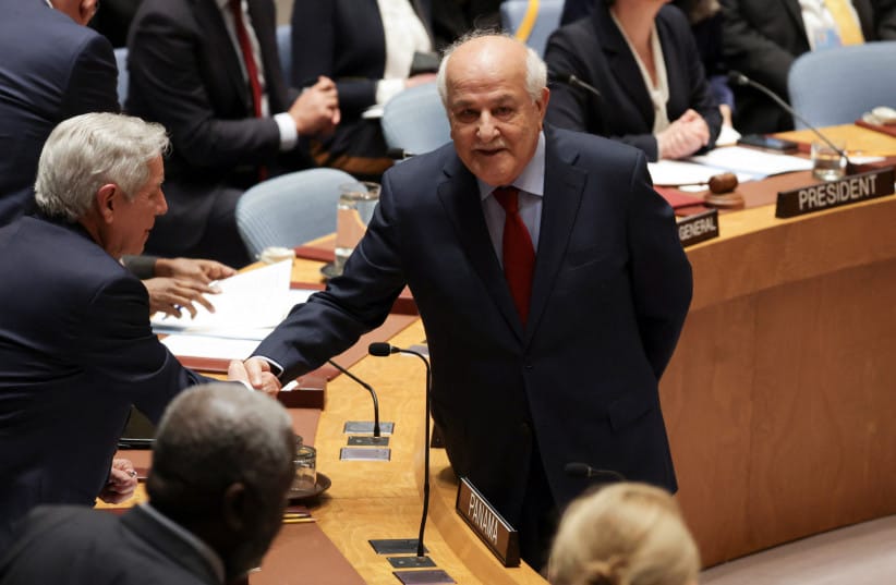 RIYAD H. MANSOUR, Palestinian Permanent Observer to the United Nations, shakes hands with Eloy Alfaro de Alba, Permanent Representative of Panama to the UN, before a Security Council meeting on the situation in the Middle East, at UN headquarters in New York City, US, February 18, 2026.