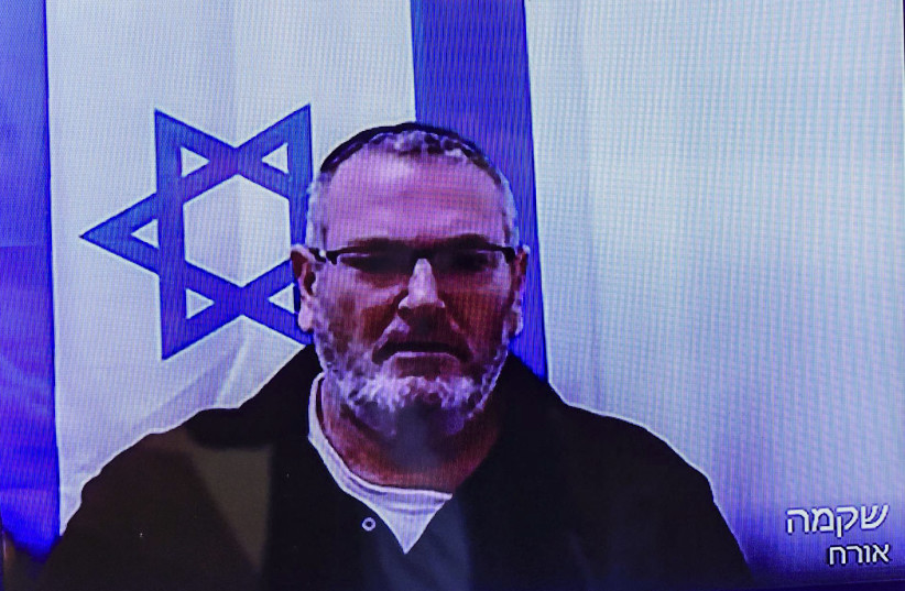 Bezalel Zini, accused of smuggling cigarettes into the Gaza Strip, is seen on a screen at the District Court in Be’er Sheva, ahead of the filing of an indictment against him, on February 5, 2026.