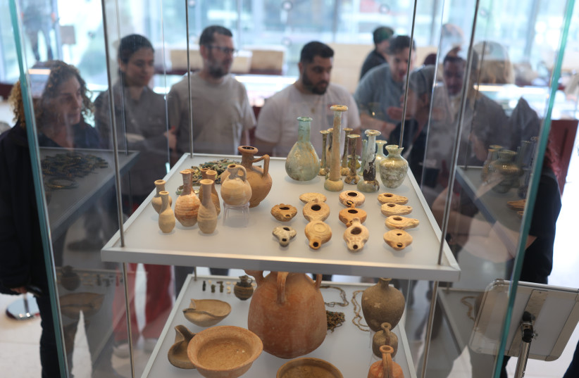 Visitors look at items stolen from ancient graves. Some can fetch up to $100,000 on the black market if they have an inscription.