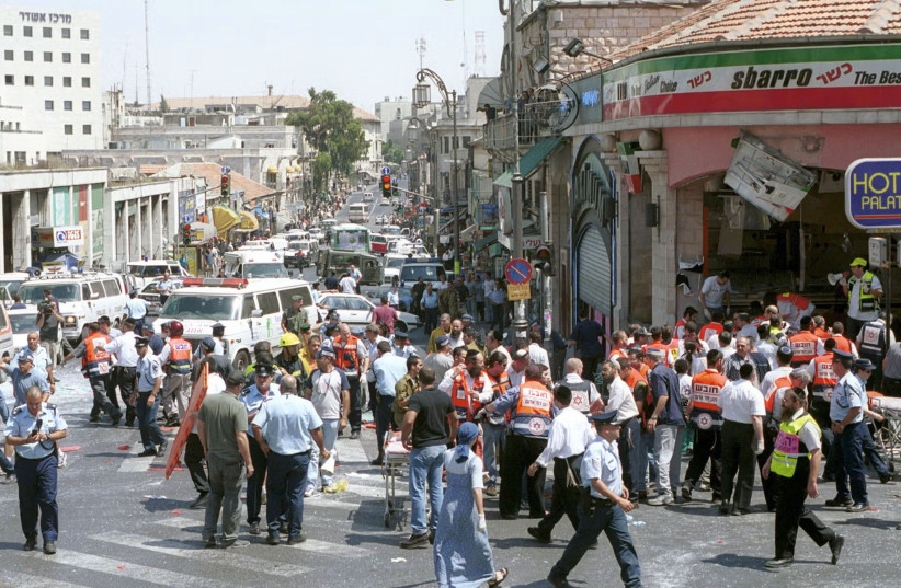 Israeli medics and volunteers treat the injured at the site of a Palestinian suicide bombing at Sbarro pizzeria on August 9, 2001 in Jerusalem, Israel.