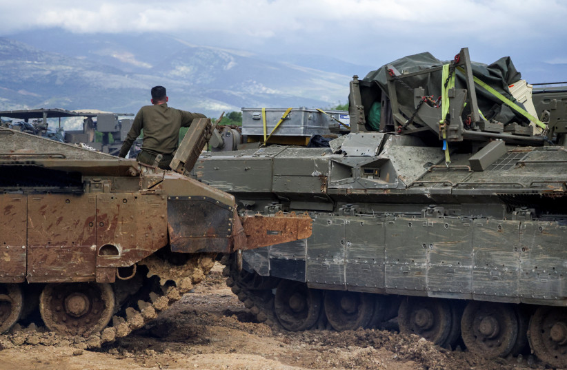 An Israeli soldier sits on a military vehicle near the Israeli side of the border with Lebanon, amid escalating hostilities between Israel and Hezbollah, as the US-Israeli conflict with Iran continues, in northern Israel, March 24, 2026.