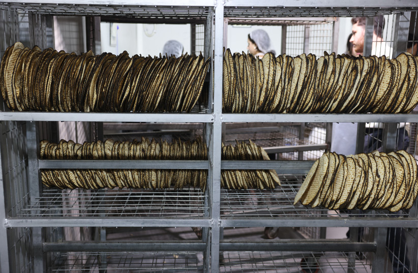 Jewish men prepare matzos, traditional unleavened bread eaten during the eight-day Jewish holiday of Passover, in the northern Israeli city of Tzfat, March 24, 2026.