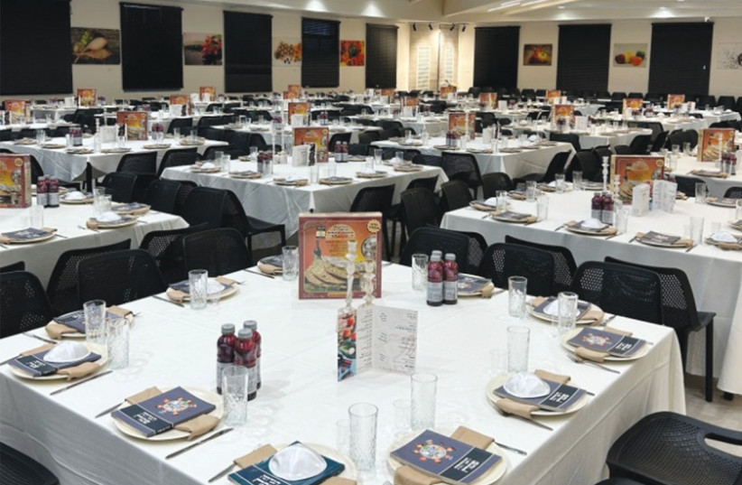 Seder-ready tables, set for a platoon.