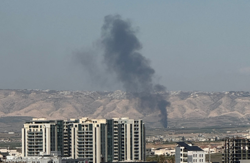 SMOKE RISES from the site of a drone crash on the outskirts of Erbil, Iraq, March 12, 2026.