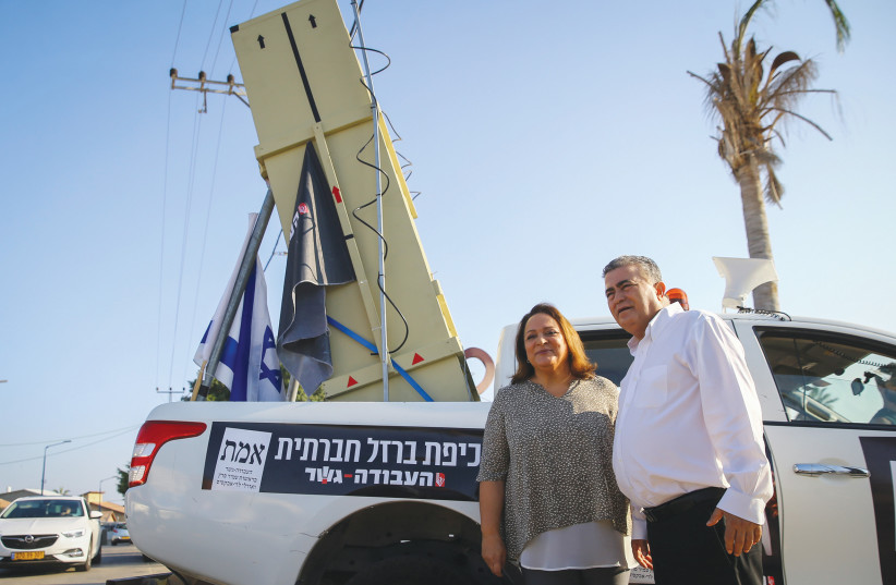 Amir Peretz stands next to an Iron Dome battery model, 2019.