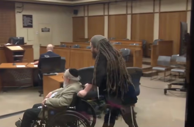Zechariah ''Zee'' Mehler pushes his father, Rabbi Peter Mehler, in a wheelchair into a courtroom for their sentencing verdict after the pair tore down a local mural depicting a Star of David turning into a swastika in Milwaukee, Wisconsin, March 25, 2026.