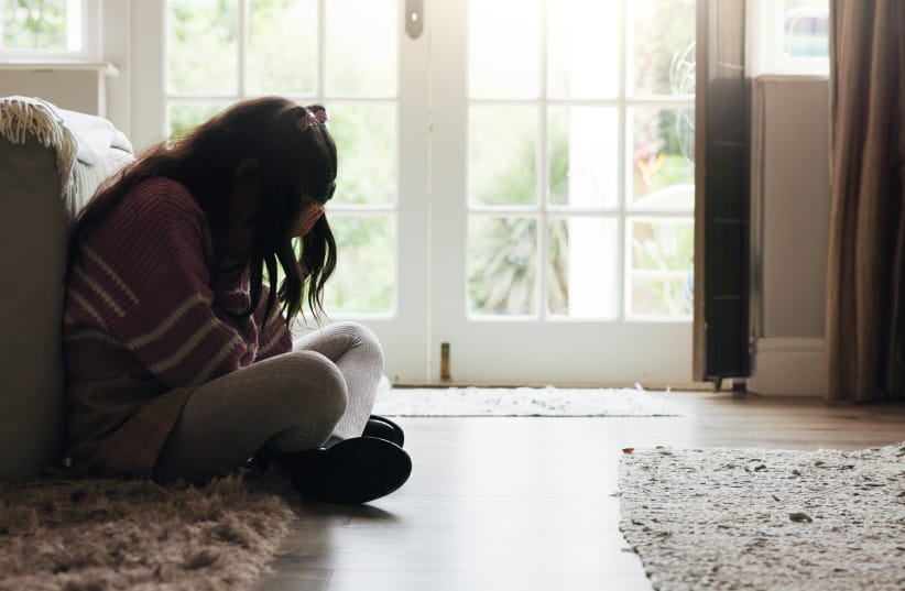 Sad, child and crying on floor in home with mental health, abuse or anxiety from trauma.