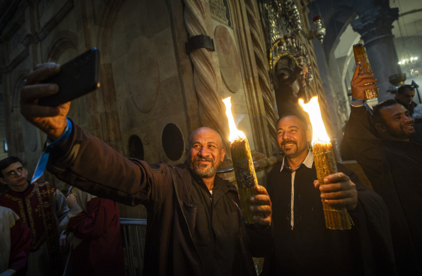 Christian worshippers take part in the Holy Fire ceremony at the Church of the Holy Sepulchre in Jerusalem's Old City during the Easter holiday on April 11, 2026.