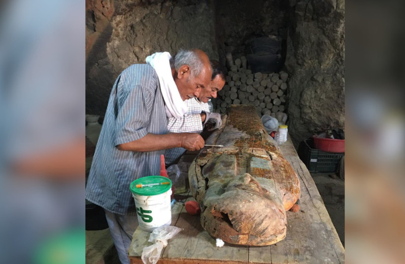 Egyptian conservationists carefully cleaning one of the sarcophagi found near Luxor, Egypt, April 15, 2026.