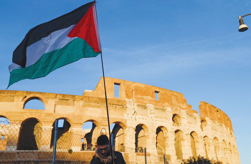 PROTESTING WITH a Palestinian flag during the nationwide union strike in solidarity with Gaza, in Rome, Nov. 2025