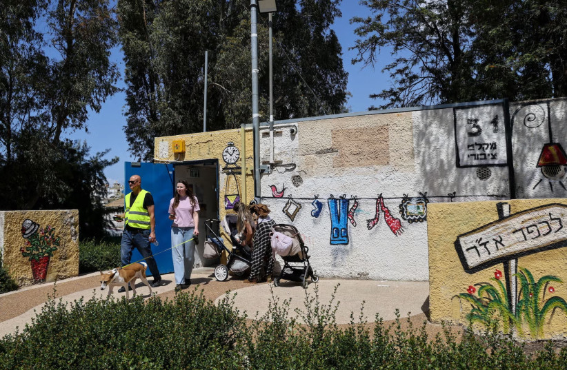 People take cover in a bomb shelter from incoming missiles fired from Iran in Holon, April 6, 2026.