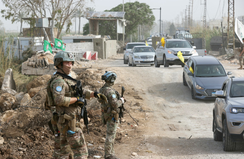 A French contingent of the United Nations Interim Force in Lebanon (UNIFIL) patrols the area as displaced residents waving Hezbollah flags make their way back to their homes on a makeshift road on April 18, 2026.