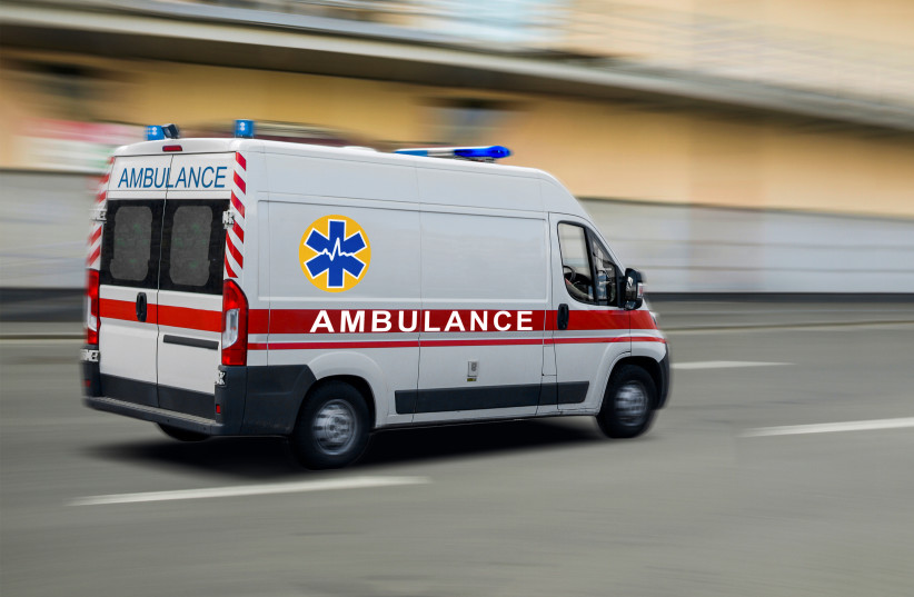 An illustrative image of an ambulance driving down a road.