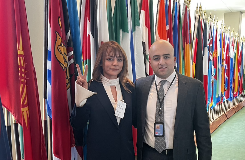 Jonathan Harounoff poses for a photo at the United Nations headquarters in New York with Shiva Amini, a former futsal player for Iran’s national team.
