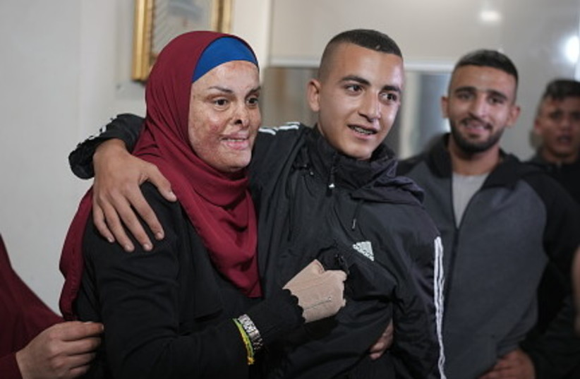 Palestinian prisoner Israa Jaabis is welcomed by her family after being released as part of a deal between Israel and Hamas on November 26, 2023 in the Jabel Mukaber neighborhood of East Jerusalem.