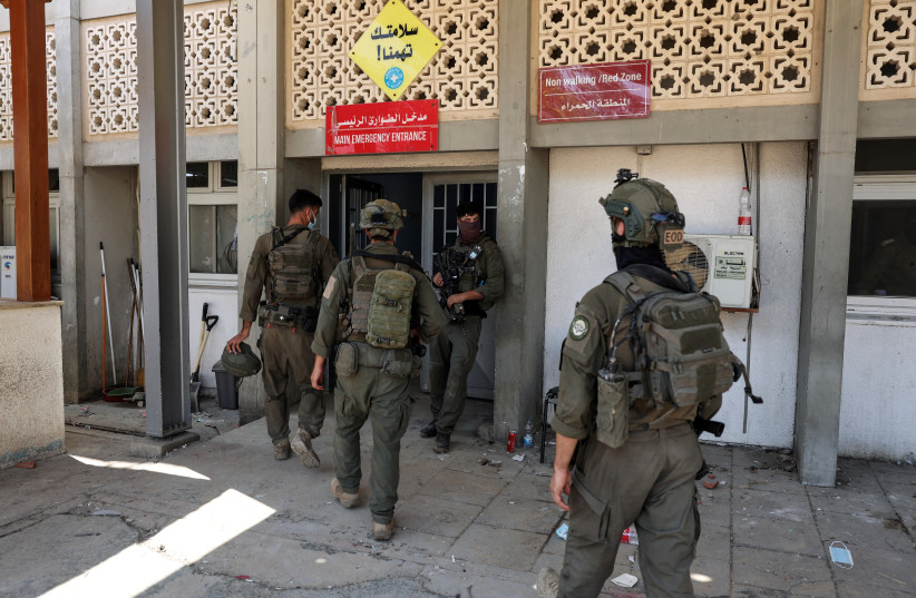 Israeli soldiers walk by the entrance to the European Hospital in Khan Younis at the Gaza Strip, where they found a tunnel underneath it, amid the ongoing ground operation of the Israeli army against Palestinian Islamist terror group Hamas, June 8, 2025.