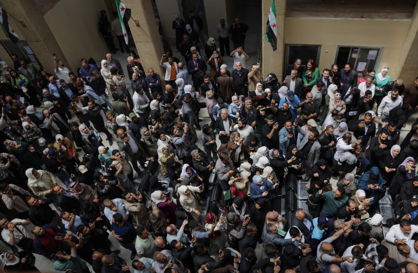 People gather at the Palace of Justice, on the day of a trial session of Atef Najib, a brigadier general and former head of the Political Security Department in Daraa during Syria's ousted President Bashar al-Assad's rule, who is accused of committing war crimes, in Damascus, Syria, April 26, 2026.