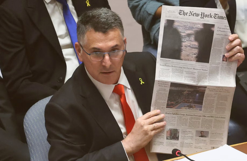 Israeli Foreign Minister Gideon Sa'ar holds up a copy of The New York Times as he speaks during a United Nations Security Council meeting at the United Nations headquarters on in New York City on August 5, 2025.