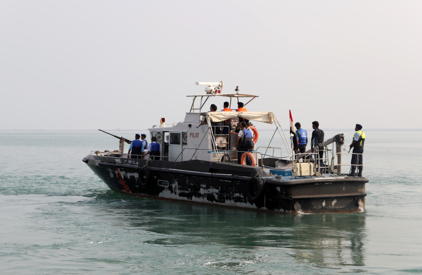 A Yemeni coast guard boat escorts a tugboat ferrying members of a Houthi delegation to attend a meeting of a committee overseeing a UN-led peace deal that will be held on board a UN-chartered ship off Yemen's port city of Hodeidah September 8, 2019.