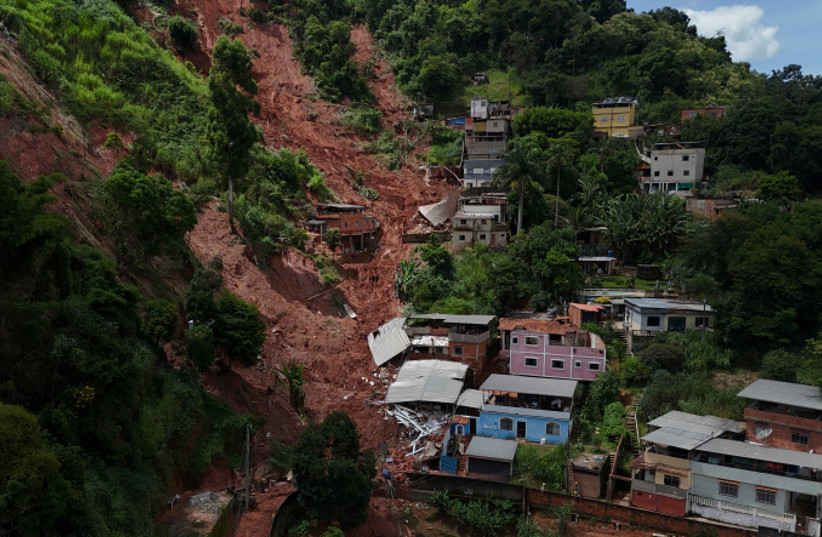 A drone view shows partially damaged houses next to a mudslide on a hill in the Tres Moinhos neighborhood, following heavy rains that killed residents and left people missing, in Juiz de Fora, Minas Gerais state, Brazil.
